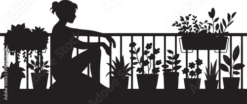 Silhouette of a person sitting on a balcony with potted plants