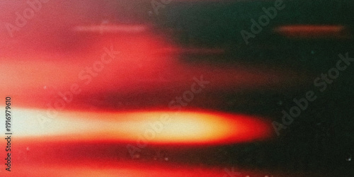 Billede på lærred Abstract blurred image featuring streaks of red orange and white light against a