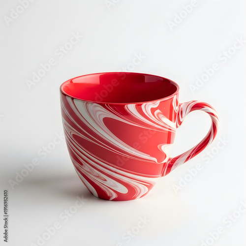 A vibrant red and white swirled ceramic mug with a handle