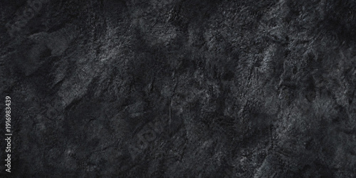 Tableau sur toile A close up textured view of dark gray rock or stone with rough uneven surfaces