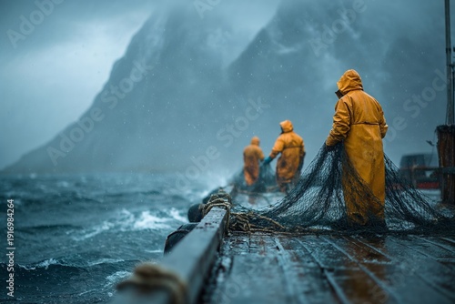 Fishermen In Yellow Raincoats Hauling Nets On Boat In Stormy Sea