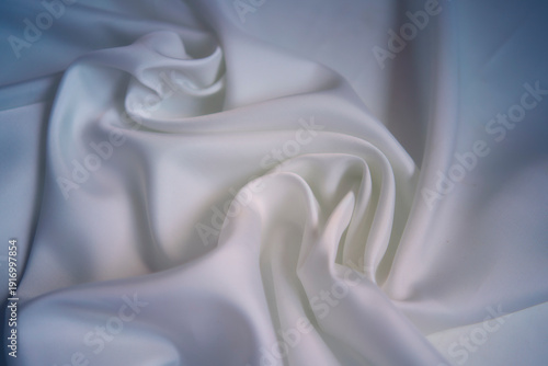 Elegant white silk fabric with soft shadows and cold blue undertone