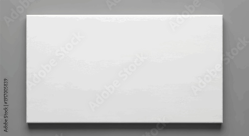 A blank white canvas rests on a gray textured background, casting a subtle shadow