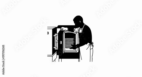 Person wearing apron placing trays into an industrial oven