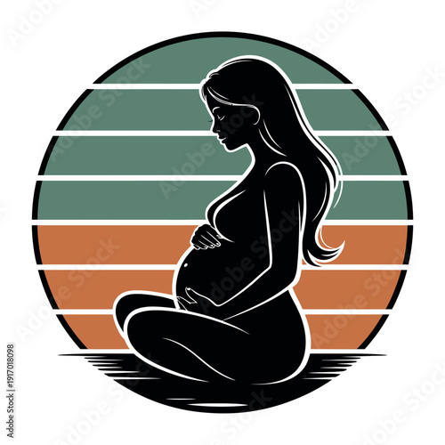 A pregnant woman sits in a meditative pose with her hands on her belly in front of a colorful striped background.