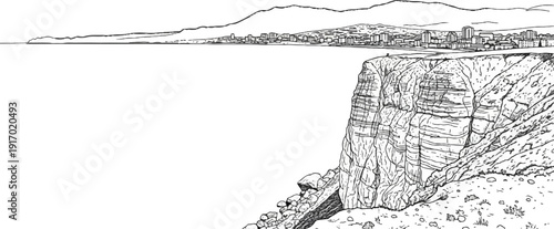 Dramatic cliff overlooking a coastal city with mountains in the background