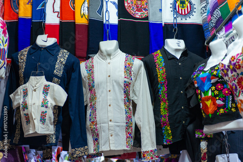 Photography Collection of embroidered guayabera shirts in various colors.