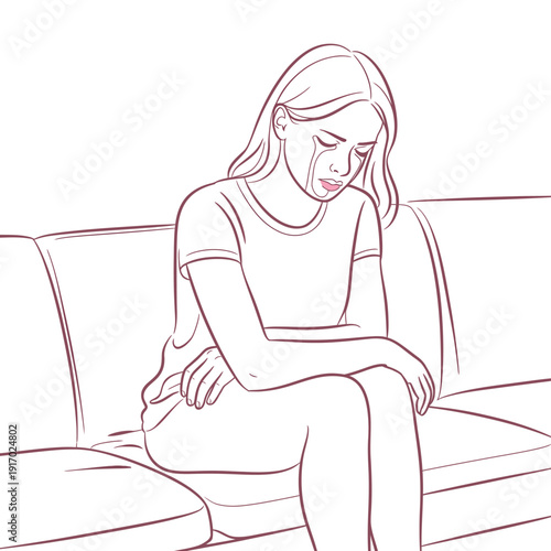 A sad woman sitting on a couch crying alone
