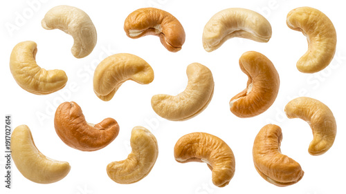 Roasted cashews in various shades of golden brown floating against transparent background