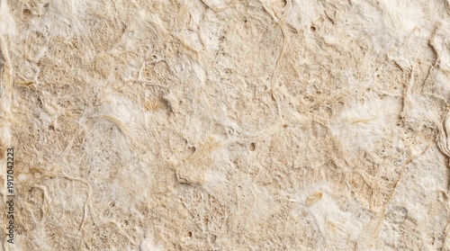 Close-up of beige travertine stone texture with natural cracks and imperfections