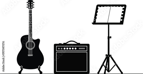 Musical instruments and accessories setup with  acoustic guitar on a stand, a guitar amplifier, and a music stand.