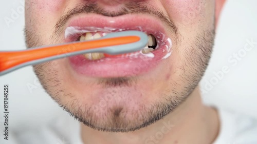 Cropped shot of a young man brushing his teeth with a toothbrush isolated on white background