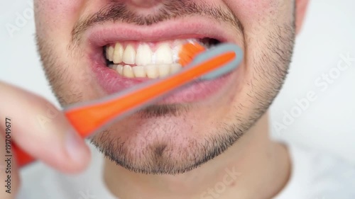 Cropped shot of a young man brushing his teeth with a toothbrush isolated on white background