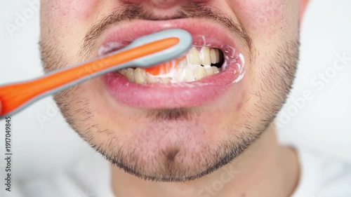 Cropped shot of a young man brushing his teeth with a toothbrush isolated on white background