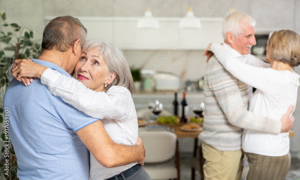 Fototapeta premium Couple dance at a house party in an apartment for elderly friends