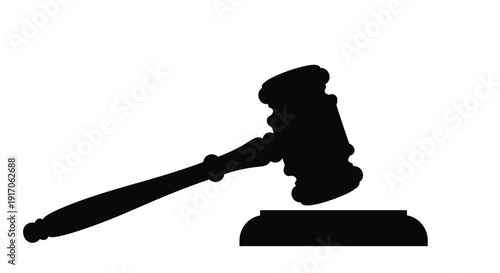 A black silhouette of a gavel resting on a wooden sound block