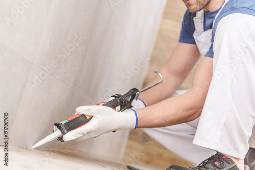 Contractor Applies Sealant in Home Renovation Project