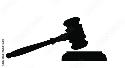 A black silhouette of a gavel resting on a sound block representing justice