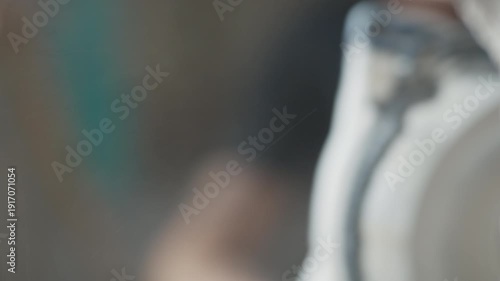 The grinder is grinding in close-up, dust is flying