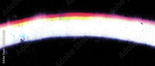 A colorful light spectrum or aurora with dark background.