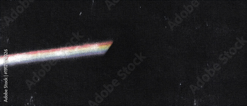 A streak of colorful light across a dark background with stars.
