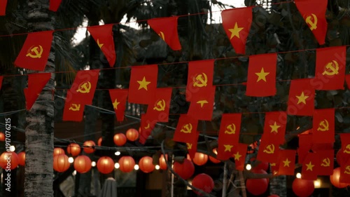 Red Flags with Star and Hammer Sickle on Tropical Night Street