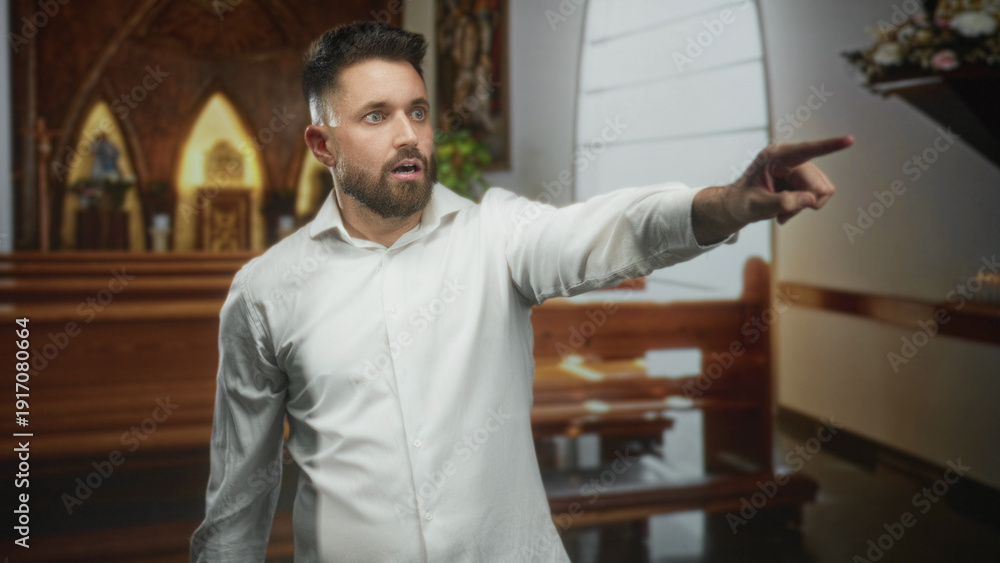 Obraz premium Man pointing finger toward altar and wooden pews inside building, smiling and speaking; invitation joy.