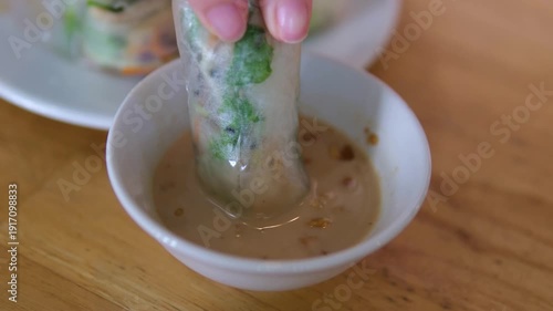fresh spring rolls dipped in peanut sauce savory soy sauce enhances its rich umami flavor. balanced combination of fresh vegetables and soy sauce creates a light, healthy and authentic Asian taste.