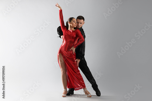 Couple of professional dancers on grey background