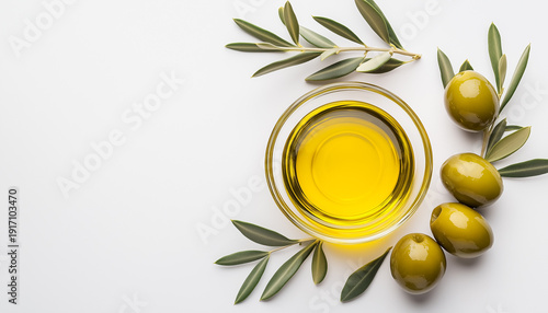 A premium olive oil with olives and fresh leaves, top view