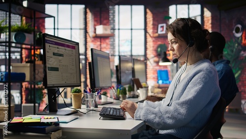 Customer support workers assist customers with technical issues by diagnosing problems. Call center agents wearing headphones in office doing deescalation and complaint resolution