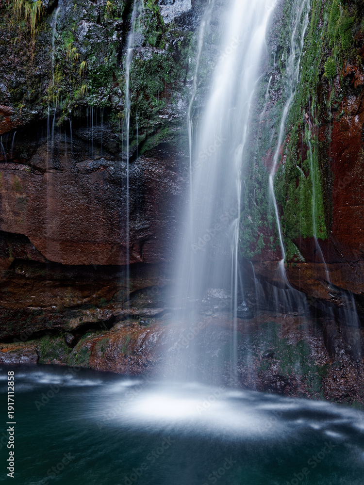Obraz premium Waterfall 25 Springs (25 Fontes) group of different streams located in Rabaçal, Paul da Serra on Madeira Island on Levada das 25 Fontes, 30m high fall in primitive forest Laurisilva of Madeira
