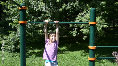 Wallpaper Mural Little girl pulls up on horizontal bar Torontodigital.ca