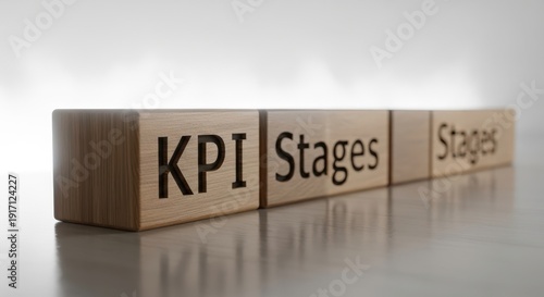 Wooden cubes featuring KPI stages positioned precisely with shallow depth and glowing white blurred atmosphere.