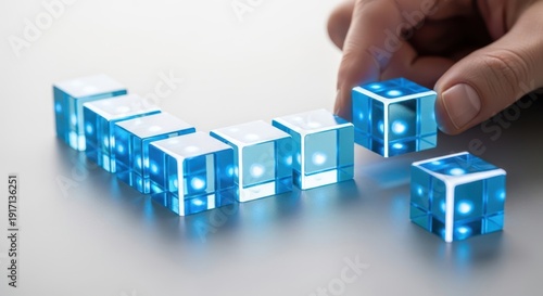 Hand organizing strategic process cubes with crisp macro sharpness and gentle white background blur for professional tone.