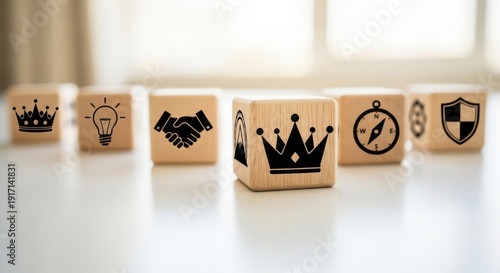 Leadership overview icons on wooden cubes placed using shallow focus and bright softly blurred surroundings.