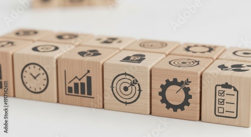 Productivity measurement icons on wooden cubes placed precisely with depth of field and crisp foreground against blurred backdrop.