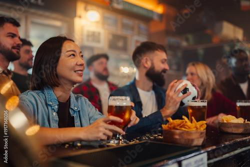 Wallpaper Mural Friends watching sports game in a lively bar with beer Torontodigital.ca