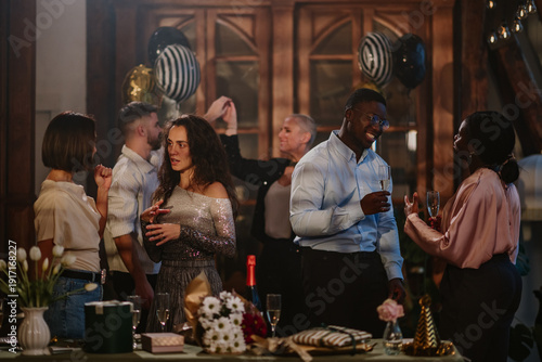 Wallpaper Mural Diverse friends enjoying a celebration, toasting with champagne, socializing and networking at an indoor party Torontodigital.ca