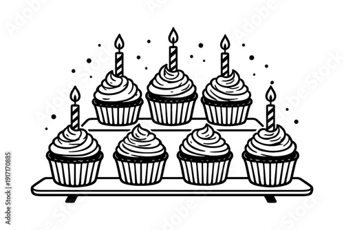 Festive cupcake display with candles on tiered stand