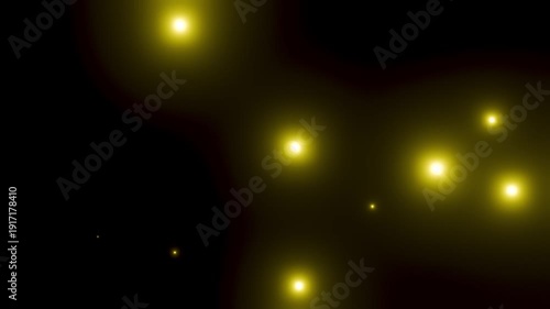 黒背景の上でたくさんの黄色に輝く粒子が飛ぶ