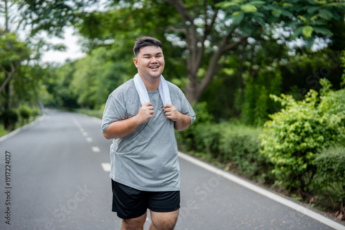 Asian plus-size man exercises outdoors in the garden to lose weight. 