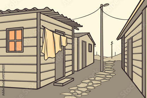 A narrow alleyway in a simple settlement with laundry hanging outside modest wooden homes.