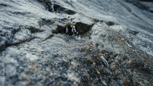Close Up of Clear Water Flowing Over Natural Grey Stone