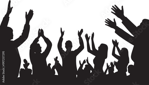 Silhouettes of people raising hands in celebration