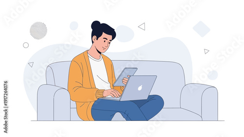 Young man working on laptop and tablet on sofa, remote work, freelance lifestyle
