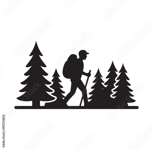 silhouette of a hiker with backpack walking through pine forest with trekking poles