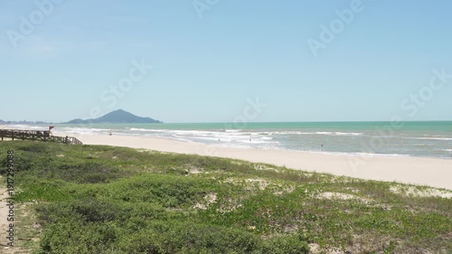 Navegantes, Brazil beach with lifeguard tower and distant hills.