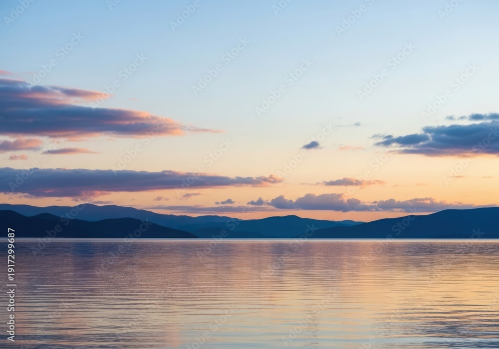 Fototapeta premium Sunset over a calm lake with colorful clouds and distant mountains