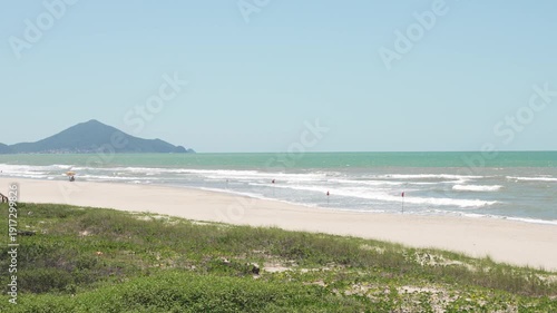 Navegantes, Brazil beach with lifeguard tower and distant hills.